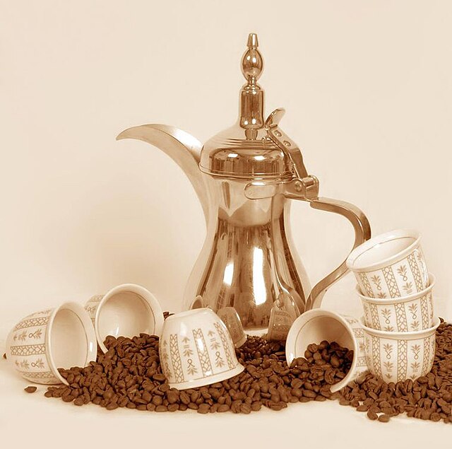 a dallah a traditional Arabic coffee pot with cups and coffee beans
